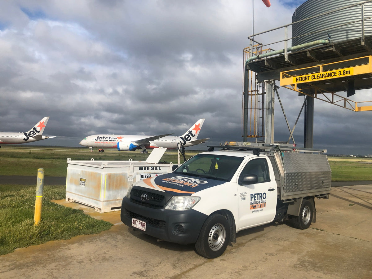 PETRO service ute parked beside a fuel tank at an airport