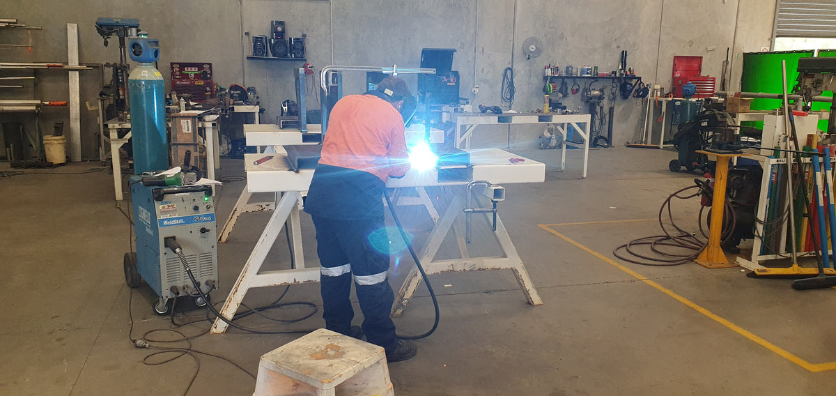 PETRO fabricator welding a steel frame in the workshop
