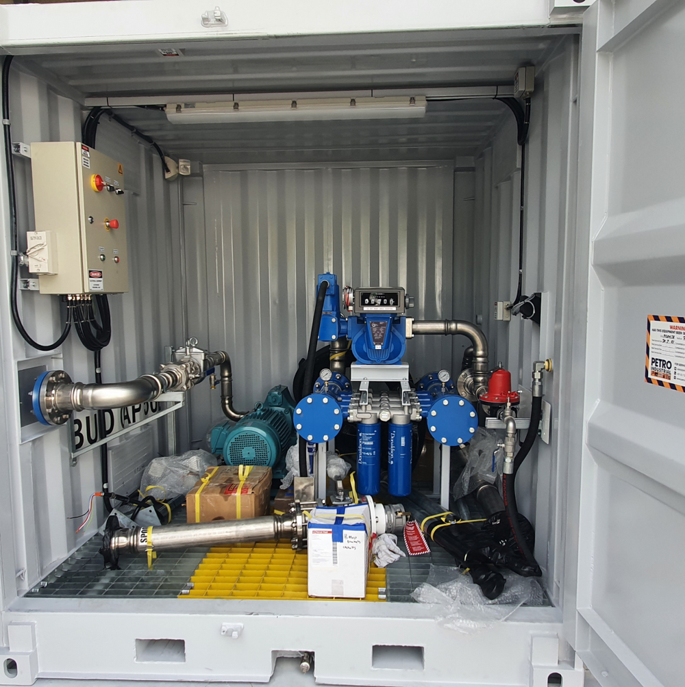 Containerised pump skid with filtration and metering inside an open shipping container