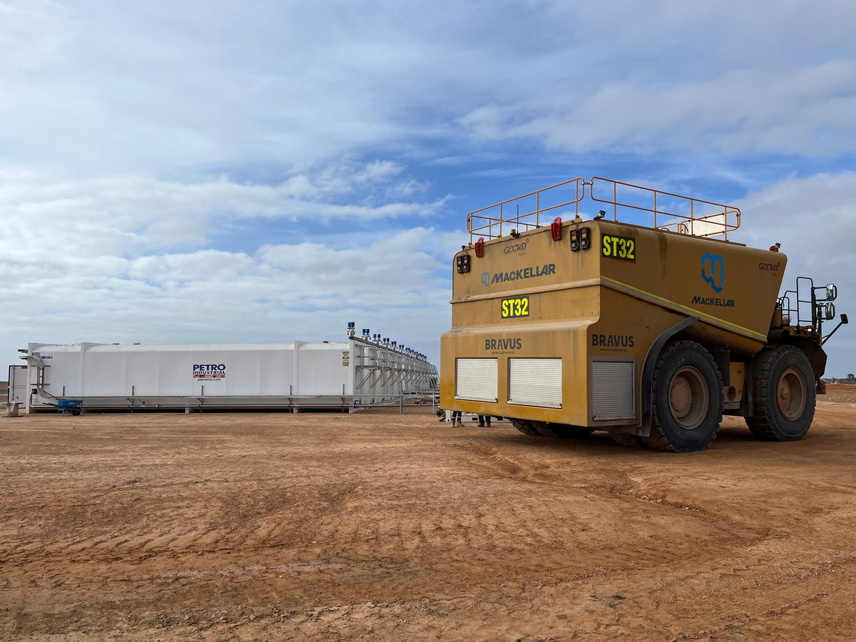 PETRO fuel farm tanks beside a haul truck on site